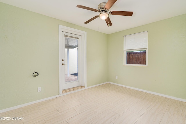 unfurnished room featuring plenty of natural light and baseboards