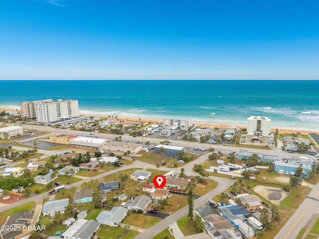 bird's eye view featuring a water view and a beach view