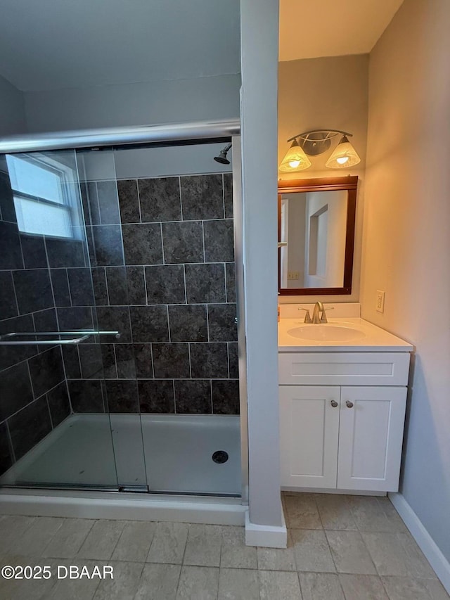 137 Beau Rivage Dr, Ormond Beach, FL 32176 - bathroom with tile patterned flooring, a shower stall, vanity, and baseboards