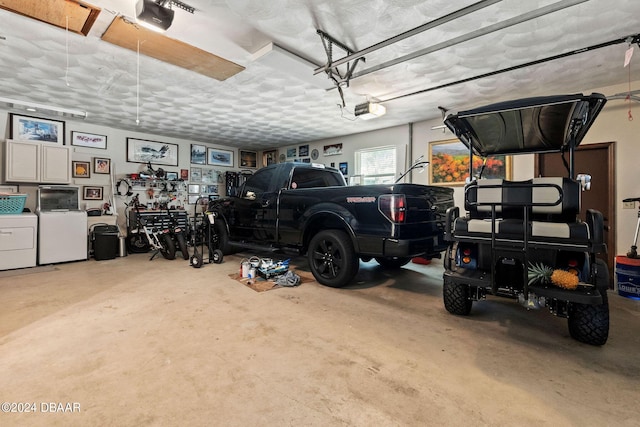 garage with washing machine and clothes dryer and a garage door opener