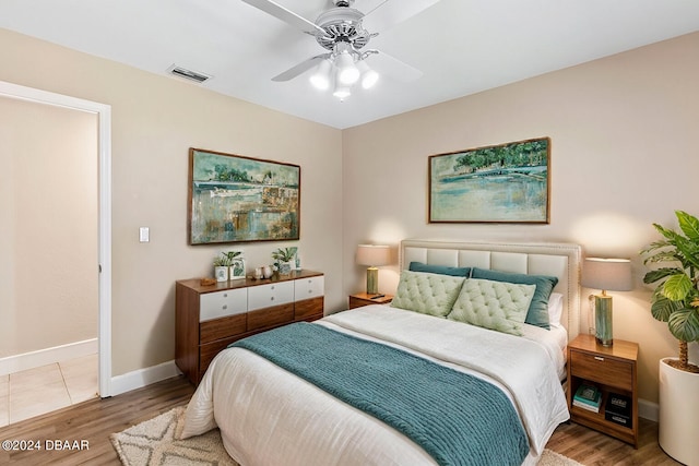 bedroom with ceiling fan and hardwood / wood-style floors