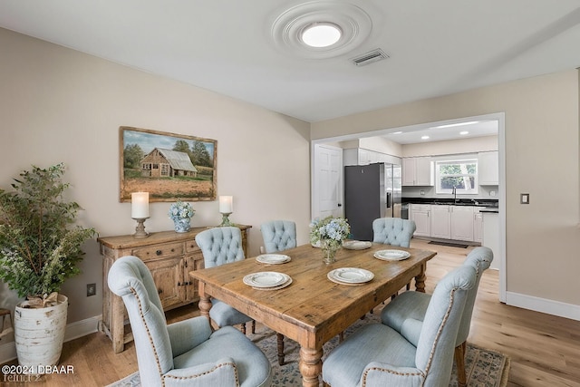 dining space featuring light wood-type flooring