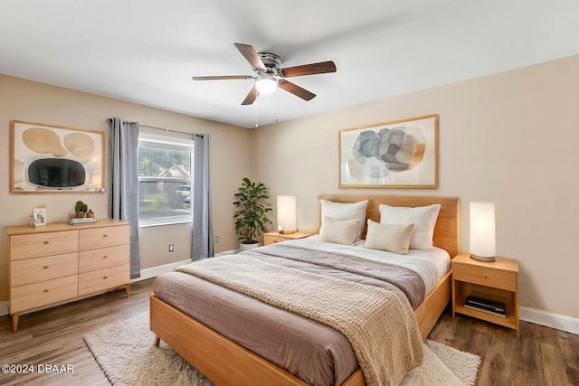 bedroom with ceiling fan and dark hardwood / wood-style floors