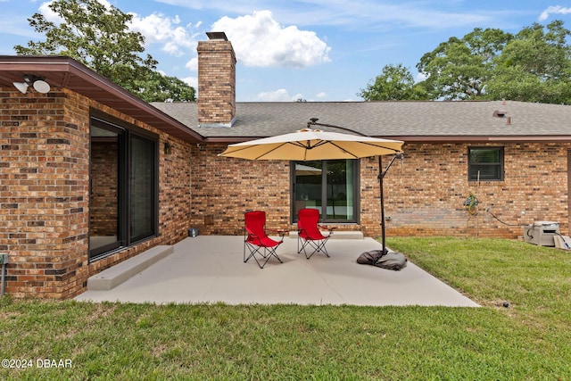 back of property featuring a yard and a patio