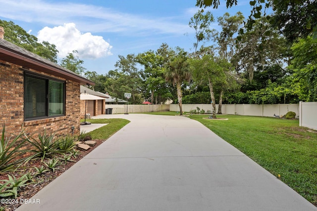 surrounding community with a lawn and a patio area