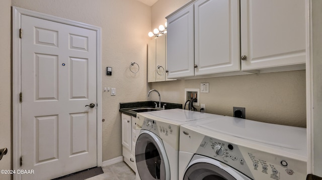 laundry room with cabinets, separate washer and dryer, sink, and light tile patterned floors