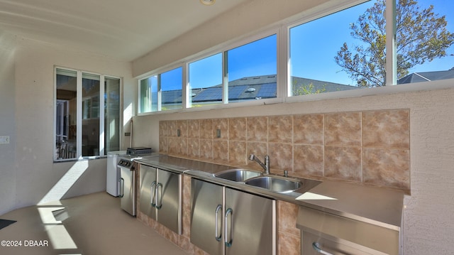 kitchen with backsplash, plenty of natural light, and sink