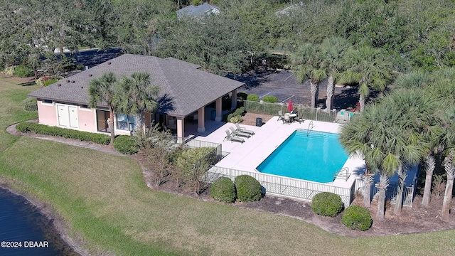 view of pool featuring a patio area and a yard