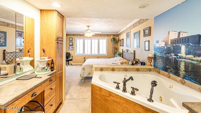 bathroom with a bathing tub, ceiling fan, tile patterned flooring, crown molding, and a textured ceiling