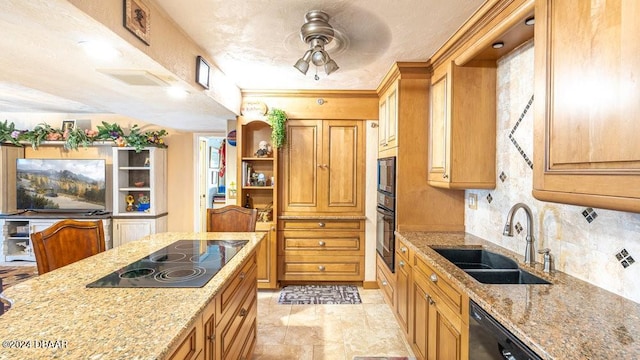 kitchen featuring backsplash, light stone counters, sink, and black appliances