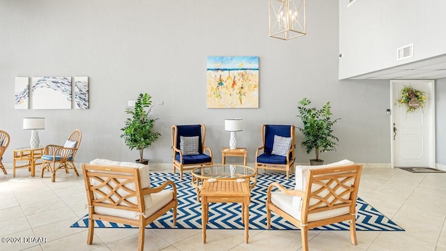 sitting room featuring light tile patterned flooring and a notable chandelier