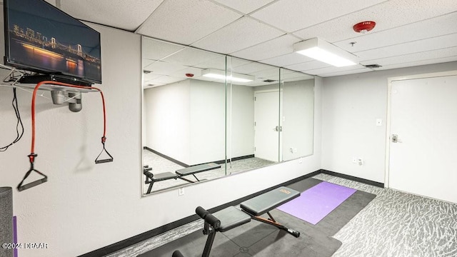 workout area featuring a paneled ceiling