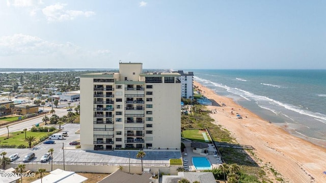 birds eye view of property with a water view and a view of the beach