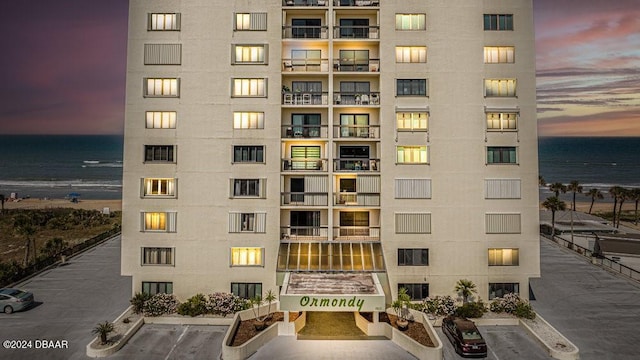 outdoor building at dusk featuring a water view