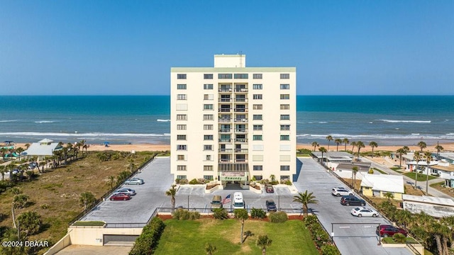 exterior space with a water view and a beach view