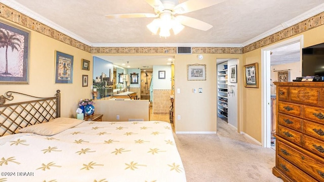 bedroom with a closet, ceiling fan, crown molding, and light colored carpet