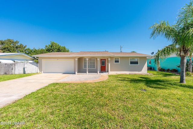 single story home featuring a front lawn and a garage