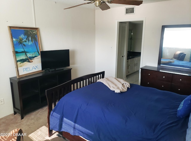 carpeted bedroom featuring connected bathroom, ceiling fan, and a textured ceiling