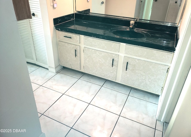 bathroom with tile patterned flooring and vanity