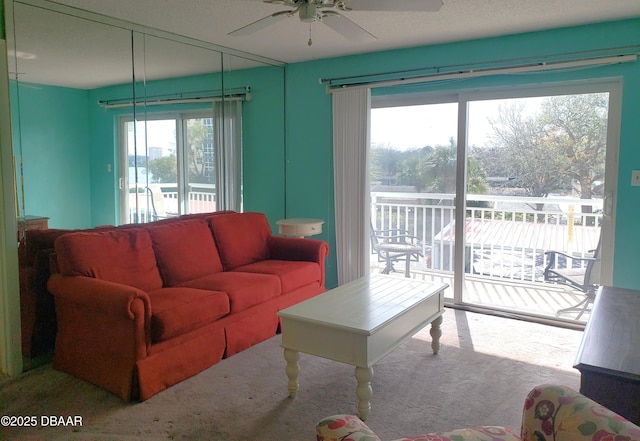 carpeted living room featuring ceiling fan