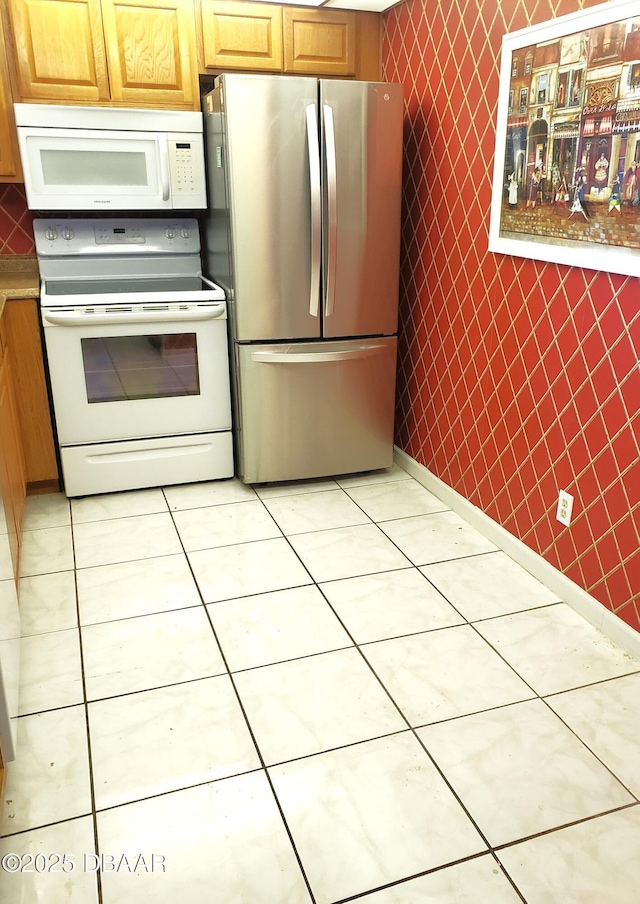 kitchen featuring white appliances and light tile patterned flooring