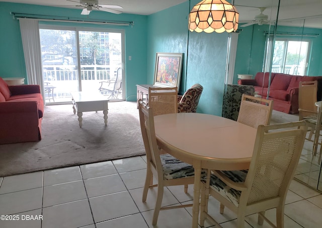 dining area featuring tile patterned flooring, ceiling fan, and a wealth of natural light