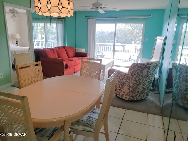 tiled dining area featuring ceiling fan and a wealth of natural light