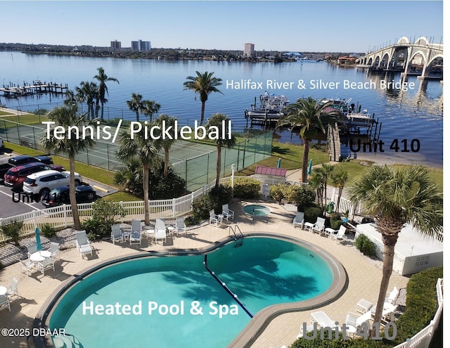 view of swimming pool with a patio and a water view