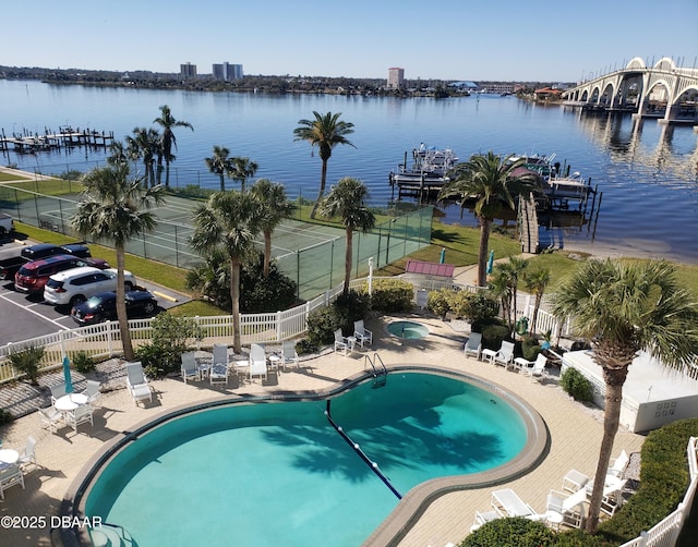 view of pool with a water view and a patio area