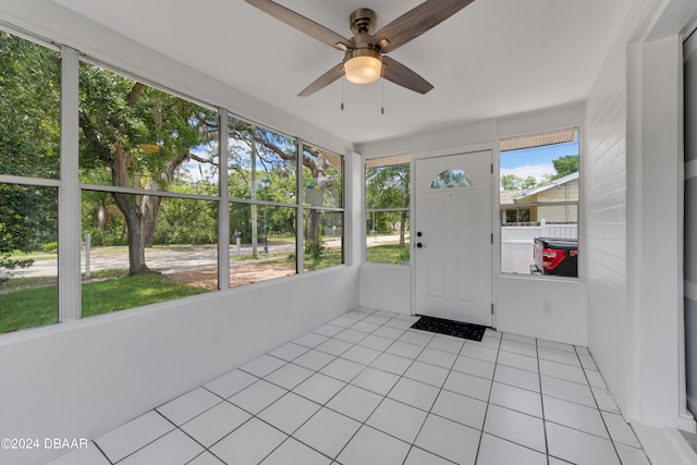 unfurnished sunroom with ceiling fan