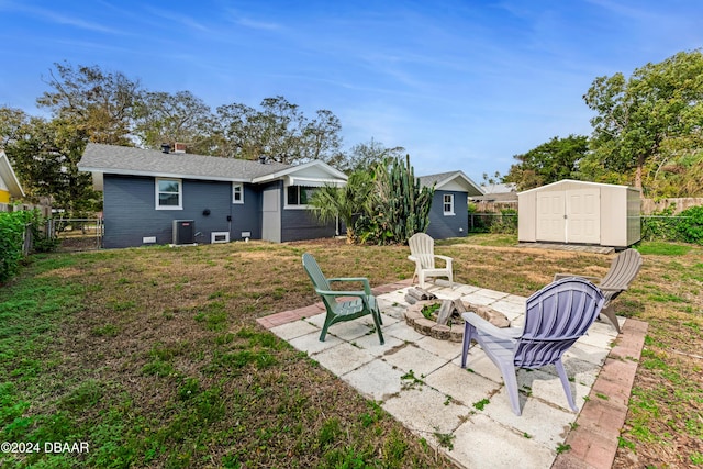 exterior space with a patio area, central AC, a fire pit, and a storage unit