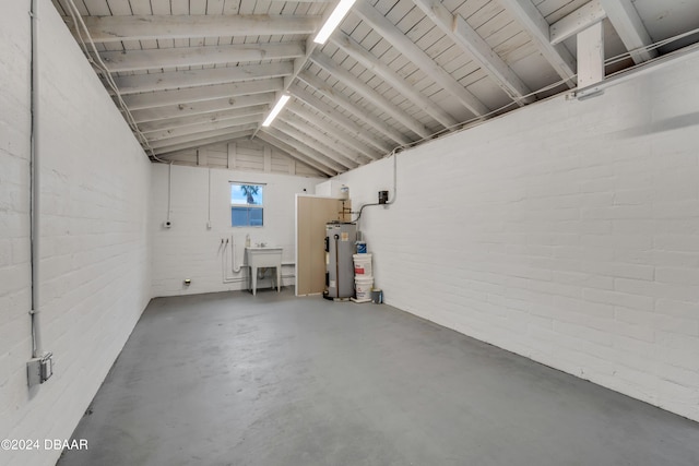 garage featuring sink and water heater