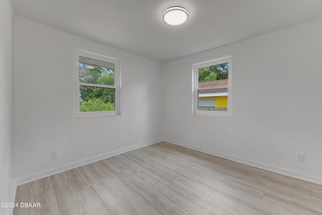 spare room with light hardwood / wood-style flooring and a wealth of natural light