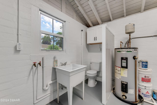 bathroom featuring sink, water heater, concrete flooring, vaulted ceiling, and toilet