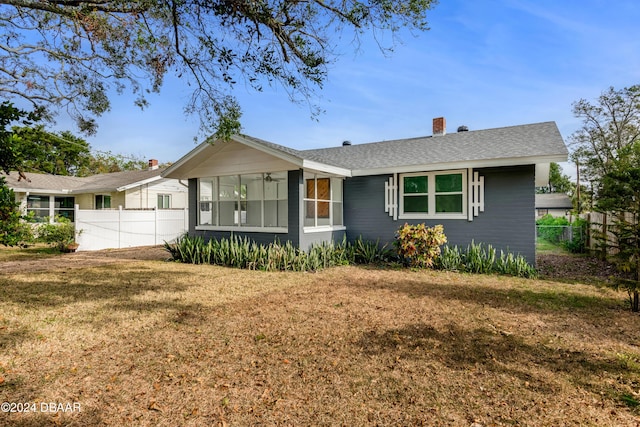 ranch-style home with a sunroom and a front yard