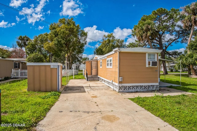 view of property exterior with fence, cooling unit, and a yard