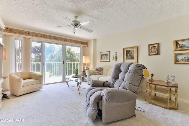 living area with a textured ceiling, ceiling fan, carpet, and baseboards