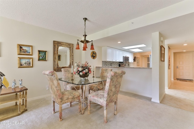 dining space featuring recessed lighting, light colored carpet, a textured ceiling, and baseboards