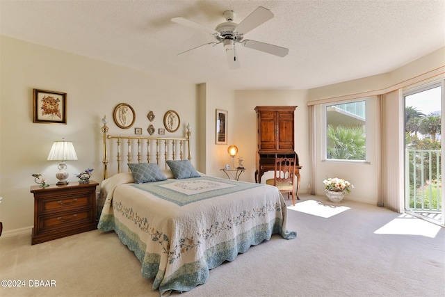 carpeted bedroom featuring access to exterior, baseboards, a ceiling fan, and a textured ceiling