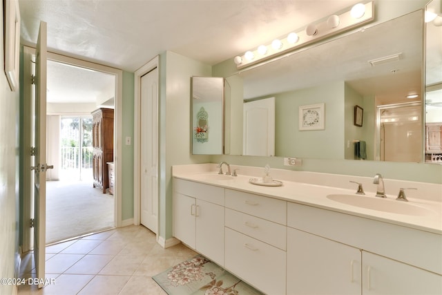 bathroom featuring double vanity, tile patterned flooring, a sink, and visible vents