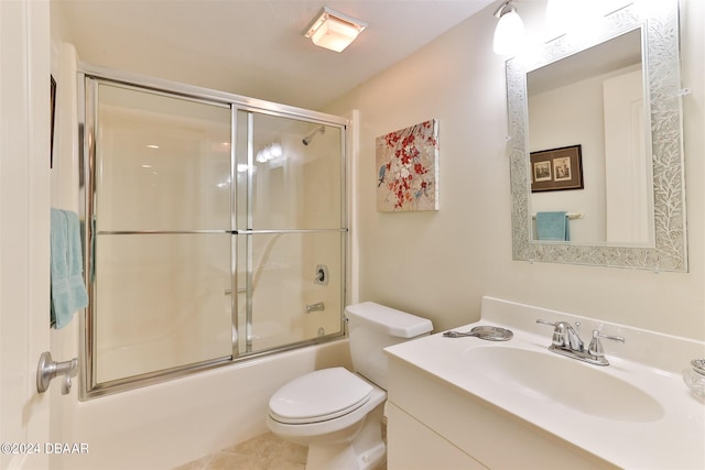 full bathroom featuring combined bath / shower with glass door, vanity, and toilet