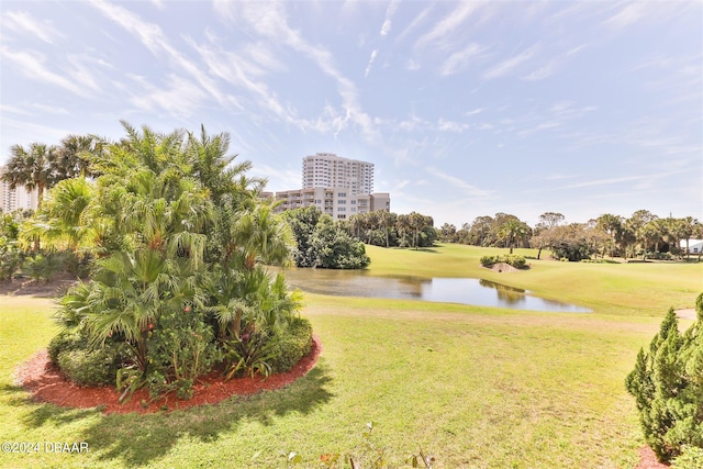 view of home's community featuring a water view and a lawn