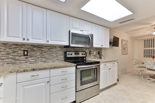 kitchen with stainless steel appliances, tasteful backsplash, visible vents, and white cabinetry