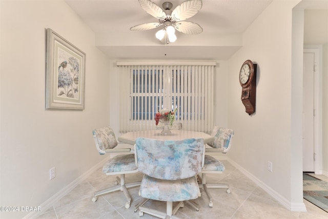 dining space featuring ceiling fan, baseboards, and light tile patterned flooring