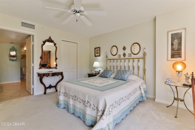 carpeted bedroom featuring a closet, visible vents, ceiling fan, and baseboards