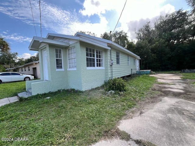 view of home's exterior with a lawn