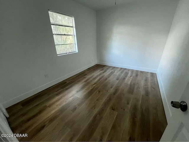 empty room featuring dark wood-type flooring