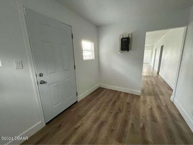 hallway featuring electric panel and hardwood / wood-style flooring