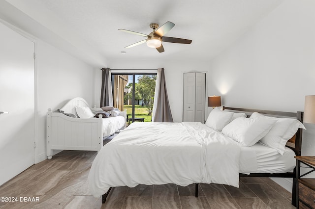 bedroom with ceiling fan, wood-type flooring, access to outside, and a closet