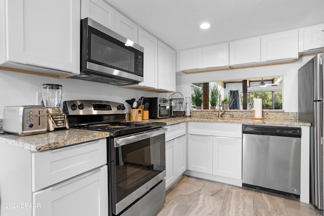 kitchen with white cabinets, sink, and appliances with stainless steel finishes